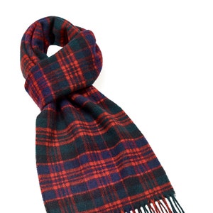 May include: A red, black, and blue plaid scarf with fringed edges.