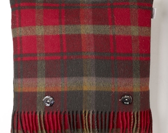 May include: Red, green and brown plaid cushion with fringe trim and two button fastenings. The cushion has a "Finelli" label.