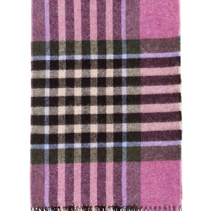 May include: A pink and brown plaid throw blanket with fringe on the edges.