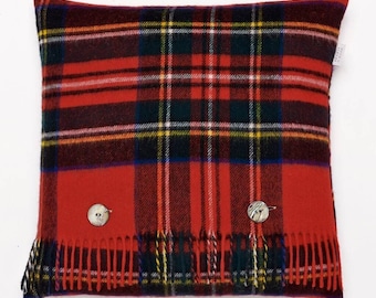 May include: Red and green tartan cushion with fringe and two button accents.