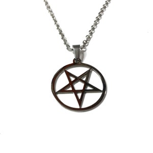 May include: A silver chain necklace with a pendant featuring a pentagram inside a circle.