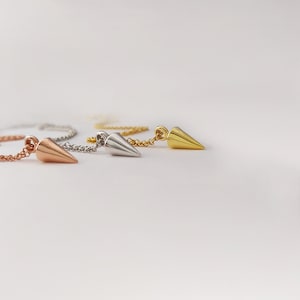 three different colors of spike necklaces