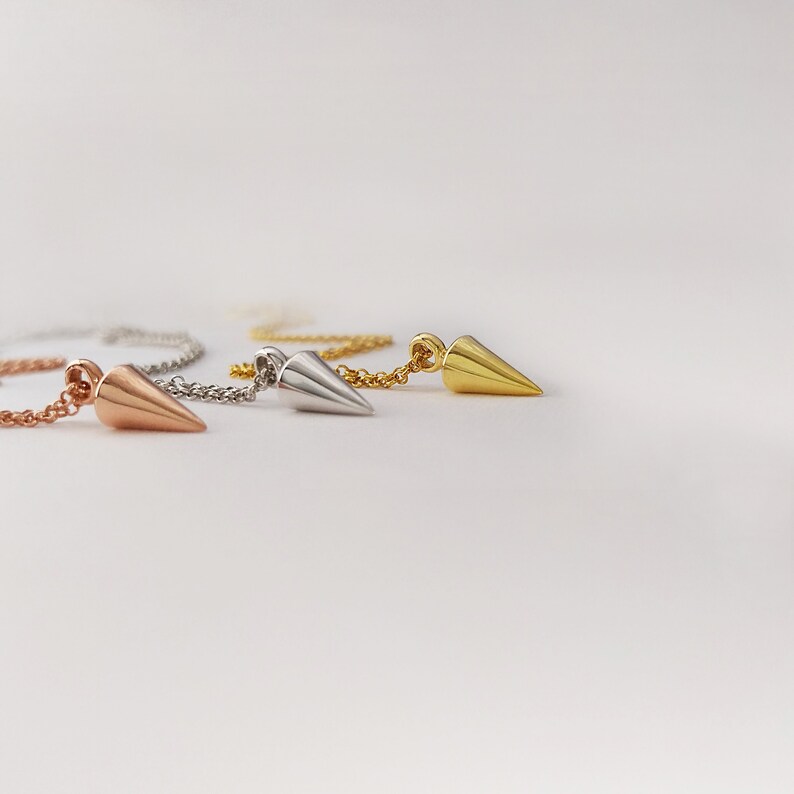 three different colors of spike necklaces