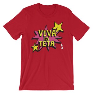 May include: Red t-shirt with a pink and yellow graphic that says "Viva la Teta" with two white teardrop shapes.