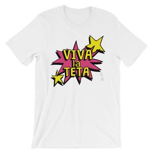 May include: White t-shirt with a pink and yellow graphic that says "VIVA la TETA" in a comic book style.