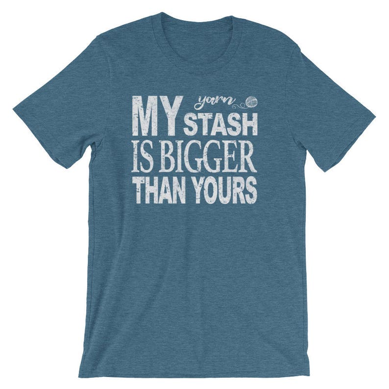 May include: A teal blue t-shirt with white text that reads "My yarn stash is bigger than yours" and a small yarn ball graphic.
