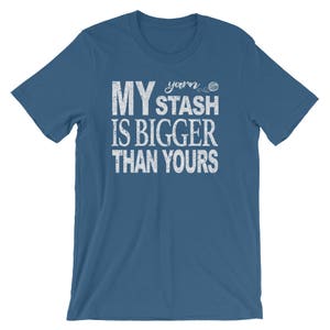 May include: A blue t-shirt with white text that reads "My yarn stash is bigger than yours".