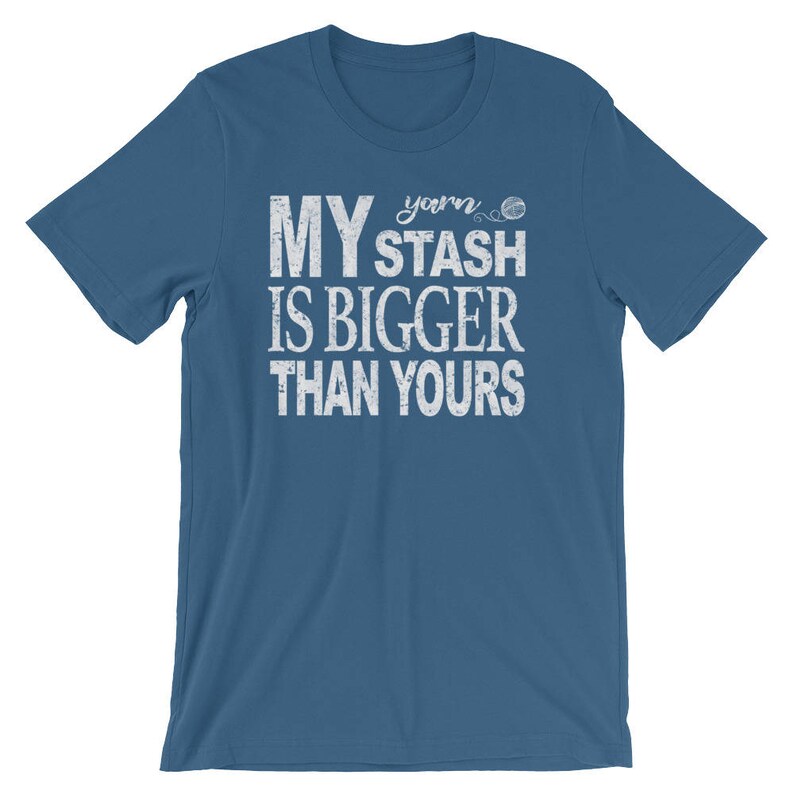 May include: A blue t-shirt with white text that reads "My yarn stash is bigger than yours".