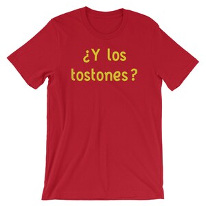 May include: Red t-shirt with the text "&iquest;Y los tostones?" in yellow.