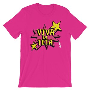 May include: Pink t-shirt with a yellow star and a speech bubble that says "Viva la Teta".