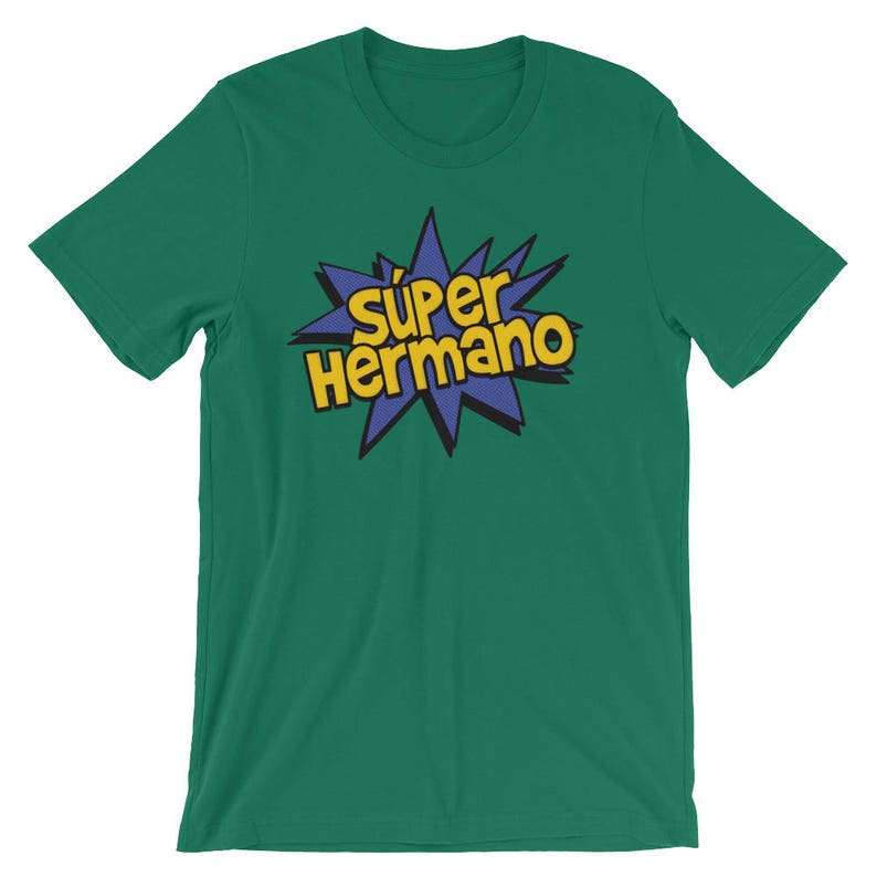 May include: Green t-shirt with the text "S&uacute;per Hermano" in yellow and blue, a comic book style design. The text is centered on the chest of the shirt. The shirt is made of a soft material.