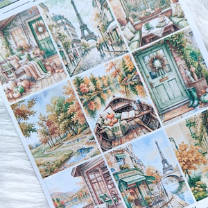 Può includere: Un foglio di adesivi intitolato FAIRY PLANNER STICKERS 113.2 - DECO BOXES con illustrazioni ad acquerello di scene autunnali, tra cui la Torre Eiffel, un portico, una barca su un lago, una porta verde e un caffè, con MYFAIRYPLANNERSTORE.ETSY.COM.