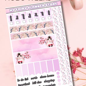 Può includere: Un foglio di adesivi per planner con un design floreale rosa e bianco. Il foglio include caselle per la pianificazione giornaliera, strisce decorative con uccelli e geishe ed etichette per attività come "lista delle cose da fare" e "shopping". Il testo "HOBO WEEKS" è in alto.