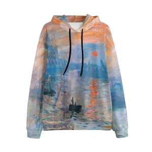 May include: A hooded sweatshirt featuring an impressionist painting of a sunrise over water. The artwork is predominantly blue, orange, and red, with a small boat and figures visible. The hoodie has a drawstring and a kangaroo pocket.