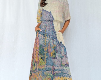 May include: A midi-length dress with a loose fit and a round neckline. The dress features a colorful, abstract print of a landscape with trees and a path. The dress has a light blue, yellow, pink, and green color scheme.
