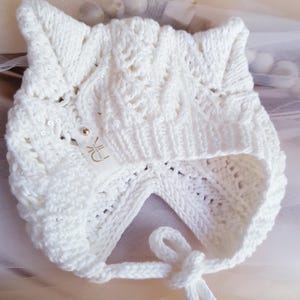 Baby cotton knitted hat. White children&#39;s bonnet made of organic cotton. Baby hat with ears.