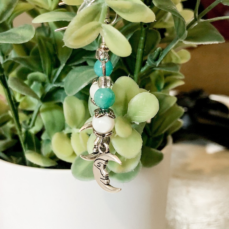 and silver moon dangle earrings. Teal cream