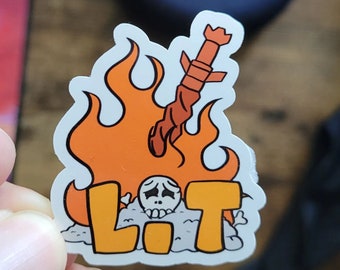 May include: A sticker with a cartoon skull in a fire with the word "LIT" written in orange letters.
