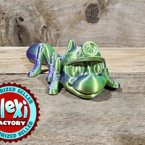 Flexing factory 3D Printed greenish Ant Miner with moving parts.