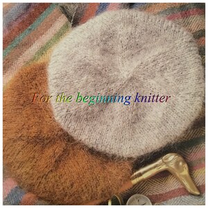 May include: A close-up of a grey knitted beret on a plaid fabric background. The text "For the beginning knitter" is visible in the image.