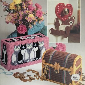 May include: A set of five plastic canvas crafts including a welcome sign with a row of cats, a heart-shaped door hanger with a teddy bear, a treasure chest, and a floral arrangement.