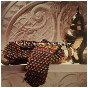 May include: A pair of colourful knitted mittens with a textured pattern. The mittens are resting on a white surface in front of a decorative gold vase. The text "For the intermediate knitter" is visible in the image.