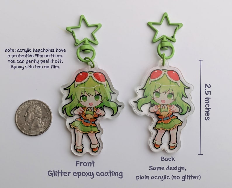 May include: Two anime-style acrylic keychains, each featuring a green-haired character with red-tinted sunglasses. The keychains are 2.5 inches tall and have a glitter epoxy coating on the front. Each keychain has a green star-shaped clasp.