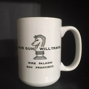 May include: White ceramic mug with a black and white illustration of a knight's head with the text "Have Gun Will Travel", "Wire Paladin", and "San Francisco".