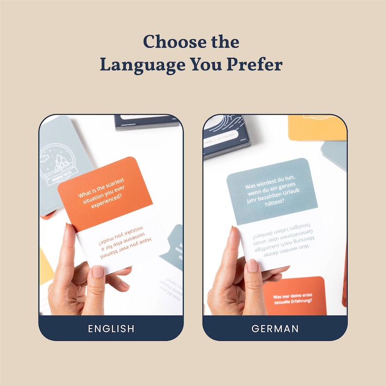 May include: Two cards with conversation starters for a game. The card on the left is orange and says "What is the scariest situation you ever experienced?" The card on the right is blue and says "Was w&uuml;rdest du tun, wenn du ein ganzes Jahr bezahlten Urlaub h&auml;ttest?" The text below the cards says "ENGLISH" and "GERMAN".