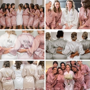 May include: A collection of satin robes in various colors including dusty rose, white, and champagne. Each robe features long sleeves with lace trim at the cuffs and hem. Some robes display embroidered text on the back or front, such as Mrs. or Matron of Honor.