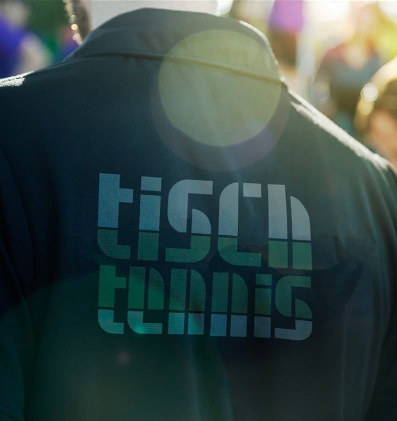 May include: A dark green shirt with a white and blue graphic that says "Tisch Tennis" on the back.