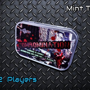 May include: A silver metal tin with a graphic of a city skyline and the words "COMBOMINATION" and "A HUMANS VS ZOMBIES ASYMMETRICAL DICE GAME FOR 1-2 PLAYERS". The tin is labelled "Mint Tin!" and "1-2 Players".
