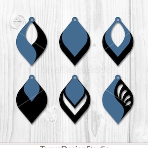May include: Six blue and black teardrop-shaped earring designs. Each earring has a unique layered design, with a blue top layer and a black bottom layer. The earrings are shown on a white wooden background. The text "TanyaDesignStudio" is at the bottom.