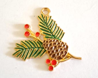 May include: A gold-toned Christmas ornament featuring a pine cone, green pine needles, and red berries. The ornament has a loop at the top for hanging. The pine cone is brown, and the berries are small and round.
