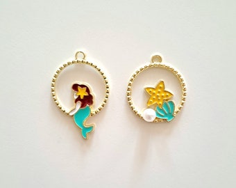 Breloques duos médaillons : sirène et étoile de mer algue couleurs émaillées contours dorés diamètre 20 mm