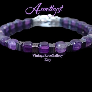 May include: A bracelet with amethyst gemstones and silver-coloured metal details. The bracelet has rectangular and rounded purple amethyst beads, with silver-coloured metal bars between them. The word "Amethyst" is written in a cursive font, and the Etsy shop name is also visible.
