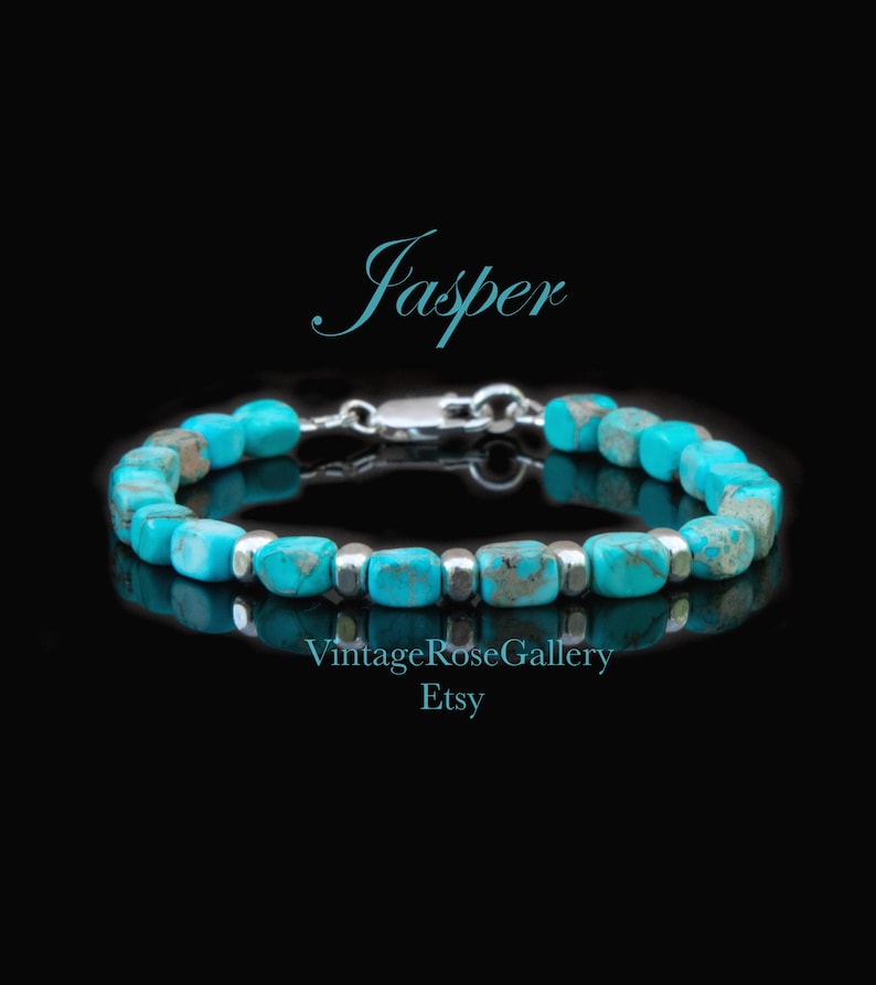 May include: A bracelet featuring turquoise-colored, rectangular jasper beads interspersed with small, polished silver-toned metal spacer beads. The piece includes a silver-toned lobster claw clasp. The text Jasper, VintageRoseGallery, and Etsy appear.
