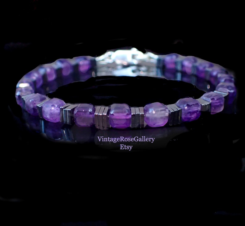 May include: A bracelet with purple gemstones and silver-coloured metal. The bracelet is shown against a dark background, emphasising its reflective properties. The Etsy shop name "VintageRoseGallery" is visible.