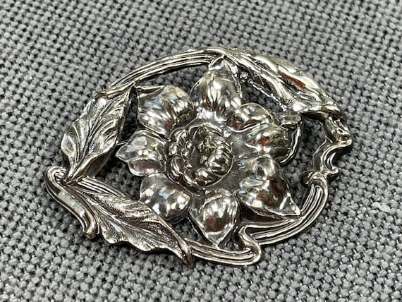 large silver brooches and pins