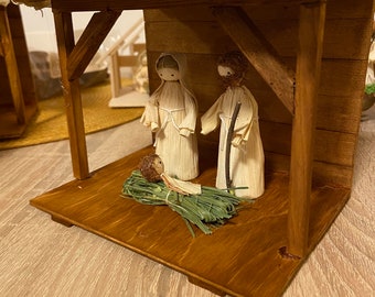 Nativity set from corn husk roof and dark wood