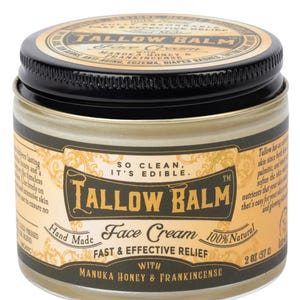 May include: A jar of Tallow Balm face cream with a black lid and a gold label. The label includes the text "Tallow Balm", "Face Cream", and "100% Natural". The jar contains 2 oz (57 g) of cream and is made with Manuka honey and frankincense.