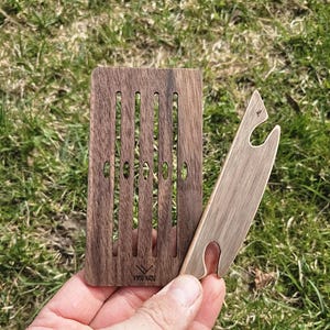 May include: A white ceramic mug with a black handle and the text "But First, Coffee" in a black, bold font. The mug is sitting on a wooden surface. The mug is approximately 4 inches tall.