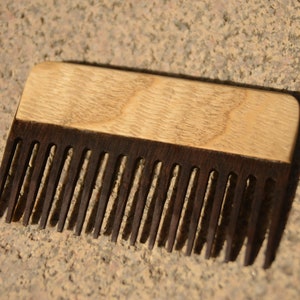 May include: A wooden comb with a light brown top and dark brown teeth.
