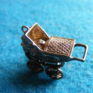 O) Vintage Sterling Silver Charm Pram with a baby