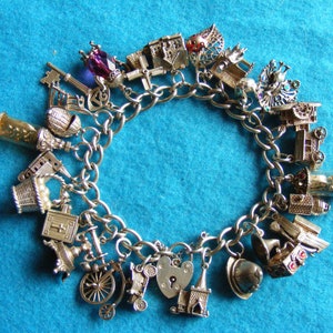 Rare Nuvo Vintage Sterling Silver Charm Bracelet with 25 Nuvo charms - some opening, crystal