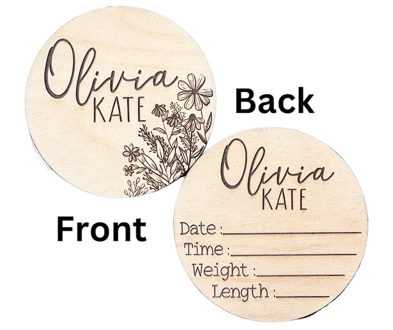 A round wooden disc with a floral design and the name Olivia Kate engraved on the front. The back of the disc has blank lines for recording a baby's date, time, weight, and length. The text on the back reads: Date:, Time:, Weight:, Length:.