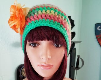 Teal pink and yellow hat with orange flower