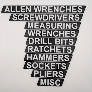 May include: Black and white tool labels with the following text: Allen Wrenches, Screwdrivers, Measuring, Wrenches, Drill Bits, Ratchets, Hammers, Sockets, Pliers, and Misc.