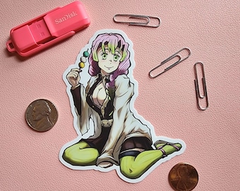 May include: A sticker featuring a cartoon anime character with pink and green hair, wearing a white and black outfit, holding a skewer of green and white dango. The character is sitting with their legs crossed and has a light green background.