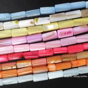 May include: Rows of rectangular beads in various colors, including light blue, white, yellow, pink, red, and orange. The beads have a glossy finish and are arranged in horizontal lines. The Etsy shop URL is visible at the bottom.